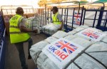 UK Aid Shelter Kits and Water Containers are loaded for shipment