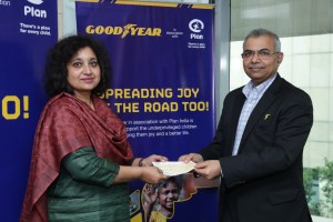 Rajeev Anand, VC and MD Goodyear India handing over cheque to Plan India